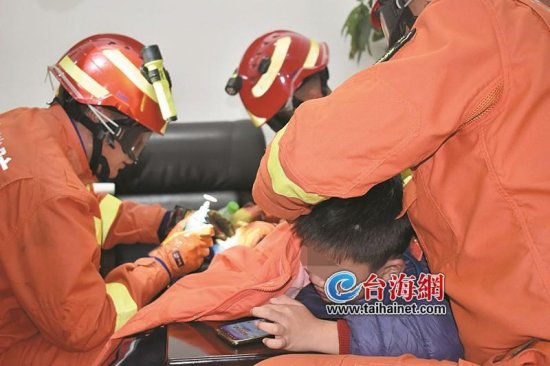 漳州：消防员小心施救 男童淡定刷手机